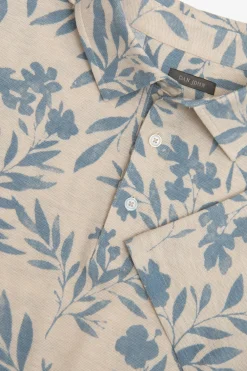 Polo in piquet fantasia fiore celeste